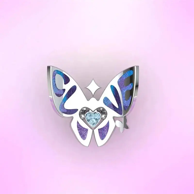 Silver butterfly ring with blue enamel wings and heart crystal centerpiece