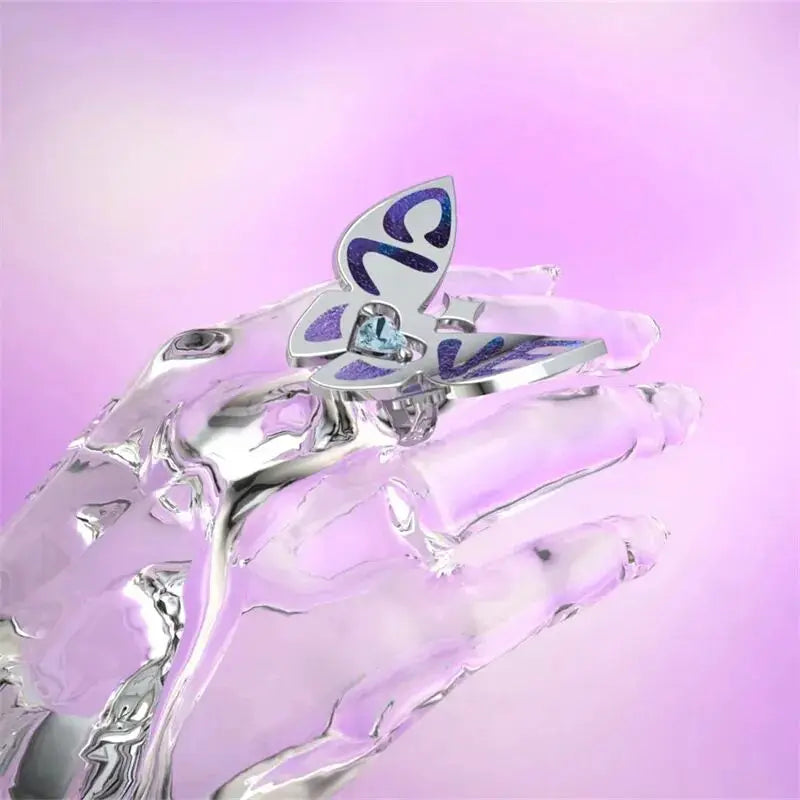 Silver butterfly ring with blue enamel wings and blue heart crystal