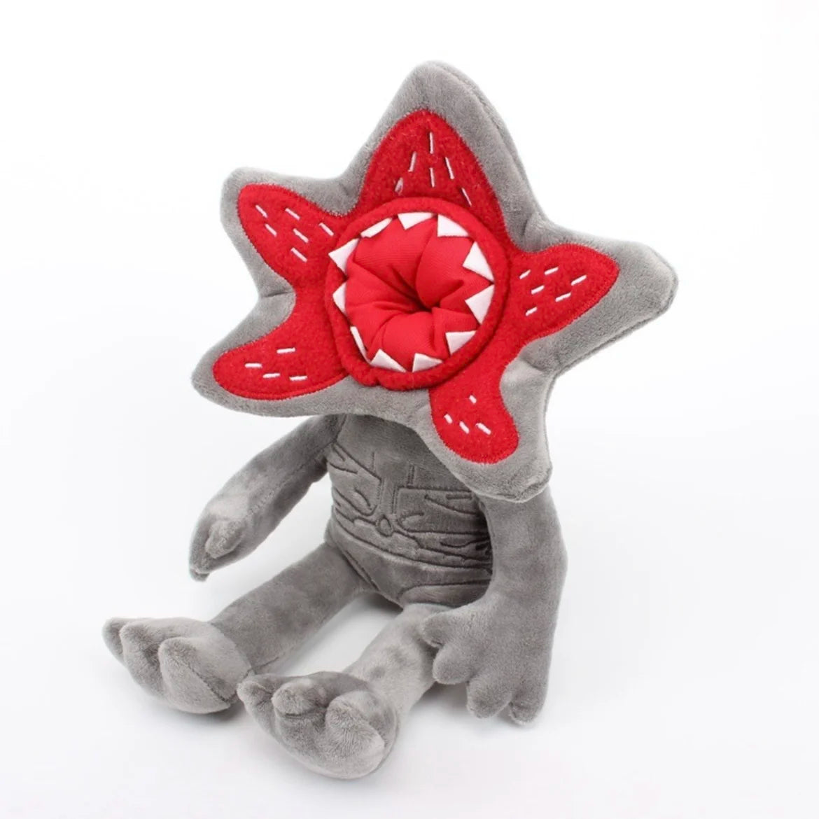 Gray plush character doll with red star hood and stitched white details
