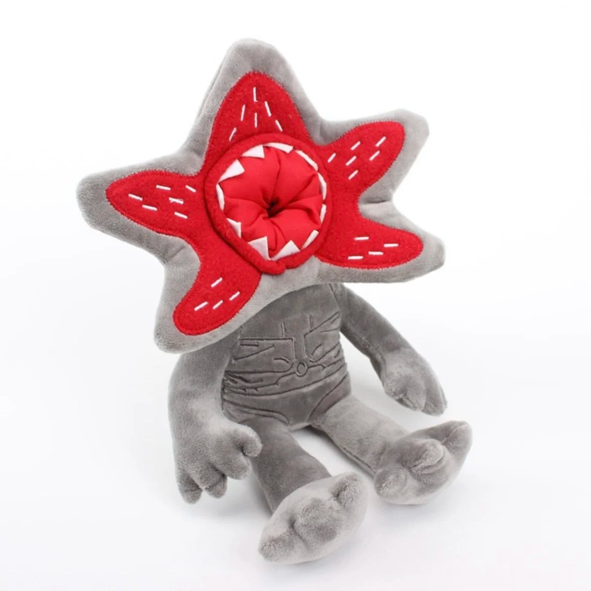 Gray plush character doll with red star hood and open red mouth detail