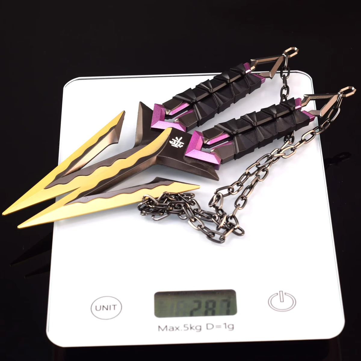Kuronami VALORANT knife keychain on white card, black with purple accents and gold tips