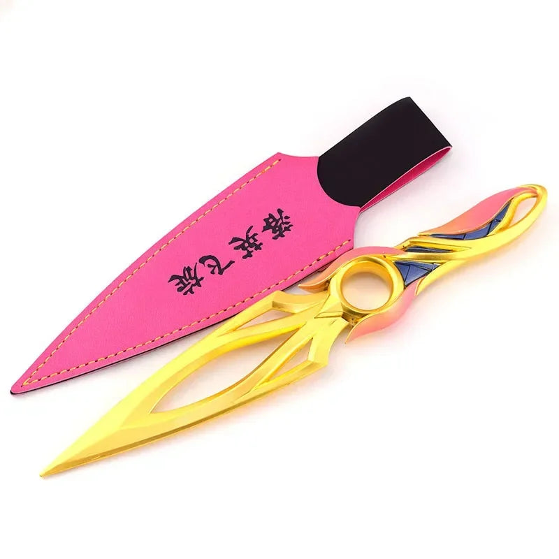 Kunai knife with pink sheath and gold blade, black spine cutout and multicolor ring