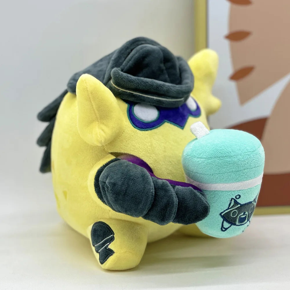 Yellow plush creature with dark hat, blue goggles, and teal drink pouch