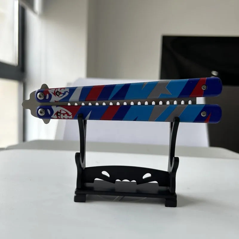 Butterfly knife hair comb set with two blue/red patterned pieces in display stand