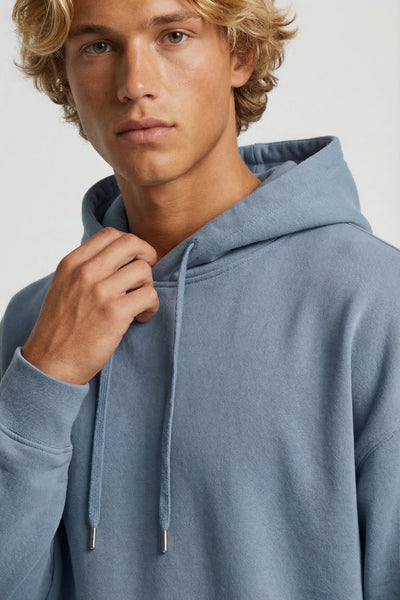 Man wearing a light blue hoodie against a plain background