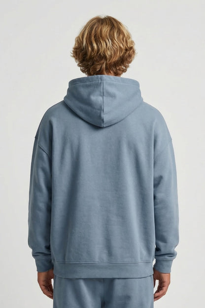Person wearing a blue tracksuit with a plain background