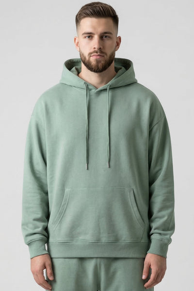Man wearing a green hoodie and pants on a white background