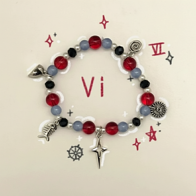 Beaded bracelet with red, light-blue, black and white beads; star, heart, and key charms.