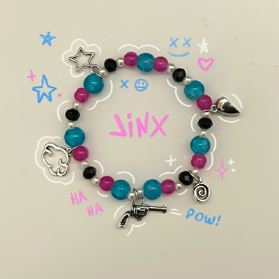 Beaded bracelet with turquoise, pink, black, and gray beads; heart and gun charms.