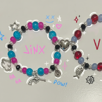 Matching beaded bracelets with turquoise, pink, black and silver charms; heart and wing details.
