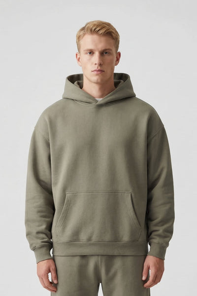 Man wearing a green hoodie and pants on a white background