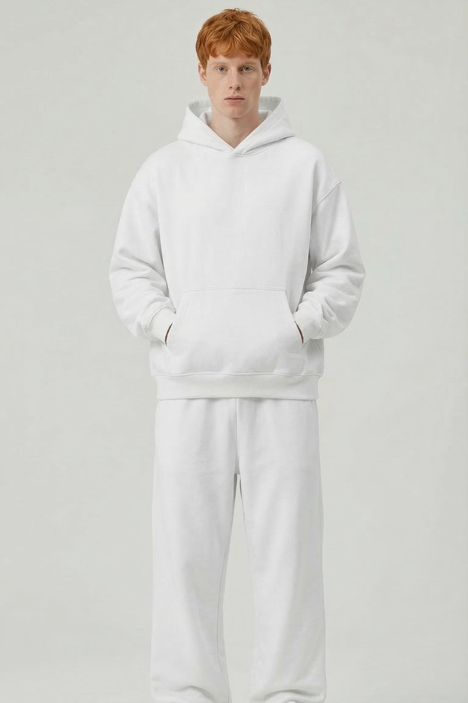 Person wearing a white tracksuit on a light gray background