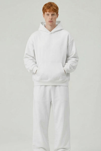 Person wearing a white tracksuit on a light gray background