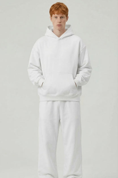 Person wearing a white tracksuit on a light gray background