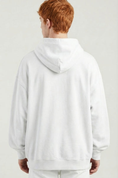 Person wearing a white hoodie and pants on a plain background