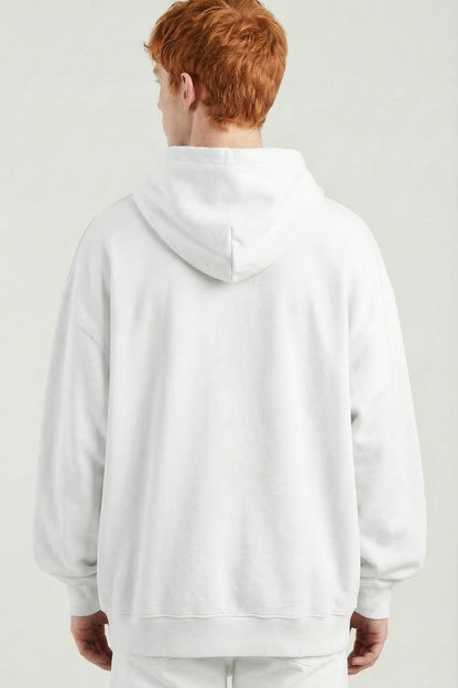 Person wearing a white hoodie and pants on a plain background