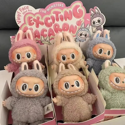 Assorted cute monster vinyl figures in a window display, fuzzy hood and large eyes