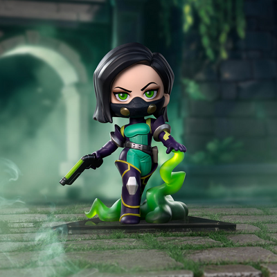 A stylized chibi figurine of a Viper ninja character with black hair, green eyes, and a black mask, wearing a teal and purple outfit with a green snake-like accessory, posed on a stone platform in a misty green outdoor setting.