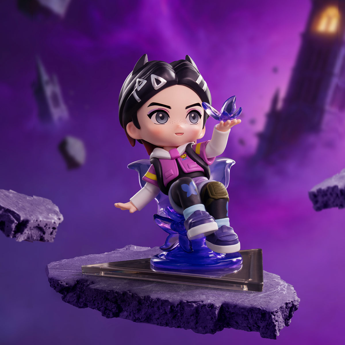 Clove A chibi-style collectible figurine of a girl character seated on a purple translucent platform, shown against a stylized purple fantasy background with floating rocks and tower silhouettes.