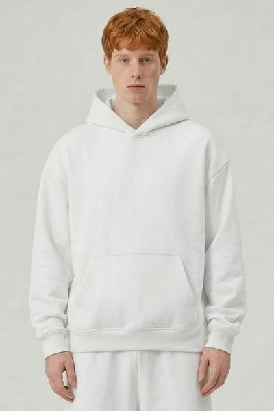 Person wearing a white hoodie and pants on a plain background