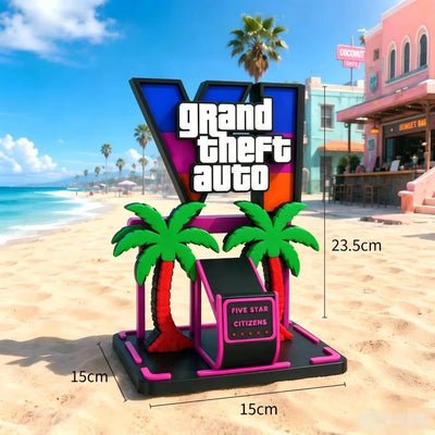 Gaming controller holder ornament with black controller, green palms, pink base; size-marked display