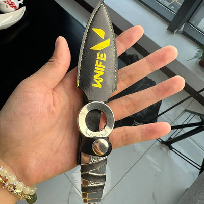 Kunai knife keychain hanging from silver ring with black sheath and yellow “KNIFE” logo