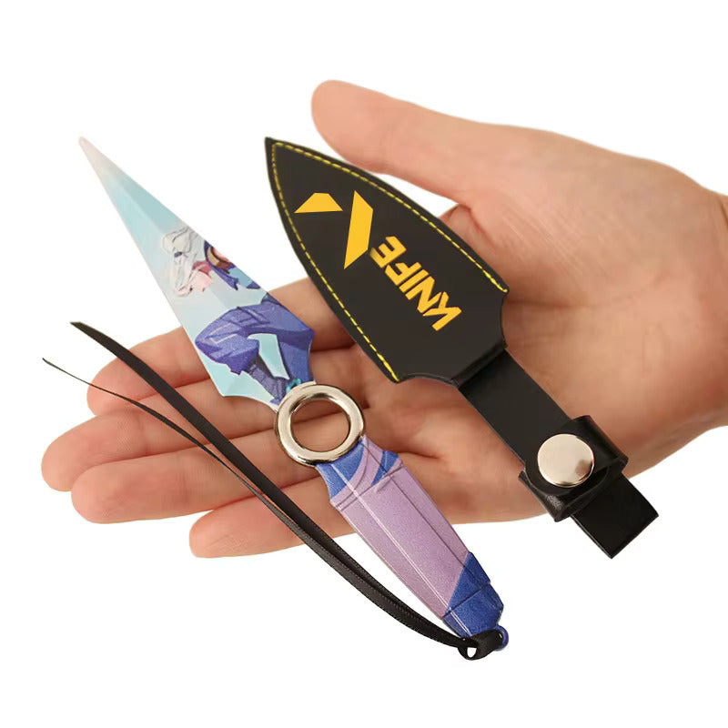 Collectible kunai knife prop with purple-blue handle, black sheath, and round metal ring pommel