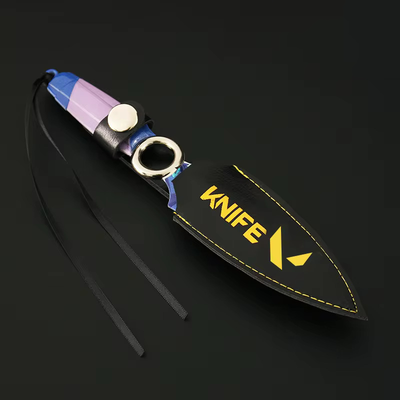 Kunai knife prop with purple-blue handle, black strap, and round metal ring; yellow logo text