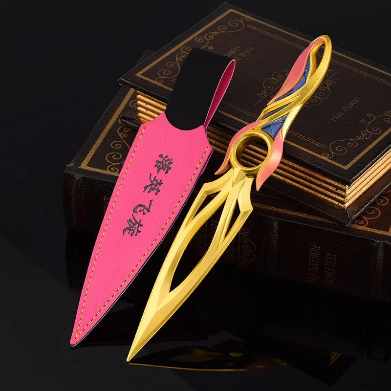 Kunai knife with pink sheath and gold blade, multicolor ring near handle, on dark books