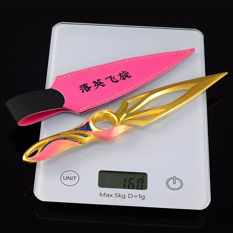 Kunai knife with pink sheath and gold blade, multicolor ring accents shown on scale