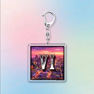 Acrylic keychain with a city photo scene and large “VI” lettering
