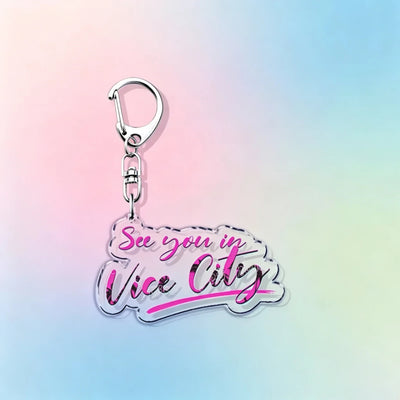 Silver hook acrylic keychain reading “See you in Vice City” in pink and white script.