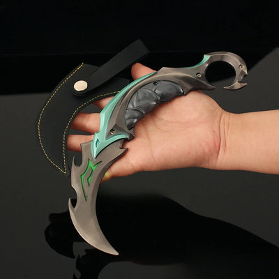Karambit knife with teal handle, silver blade, and green graphic accents held by hand