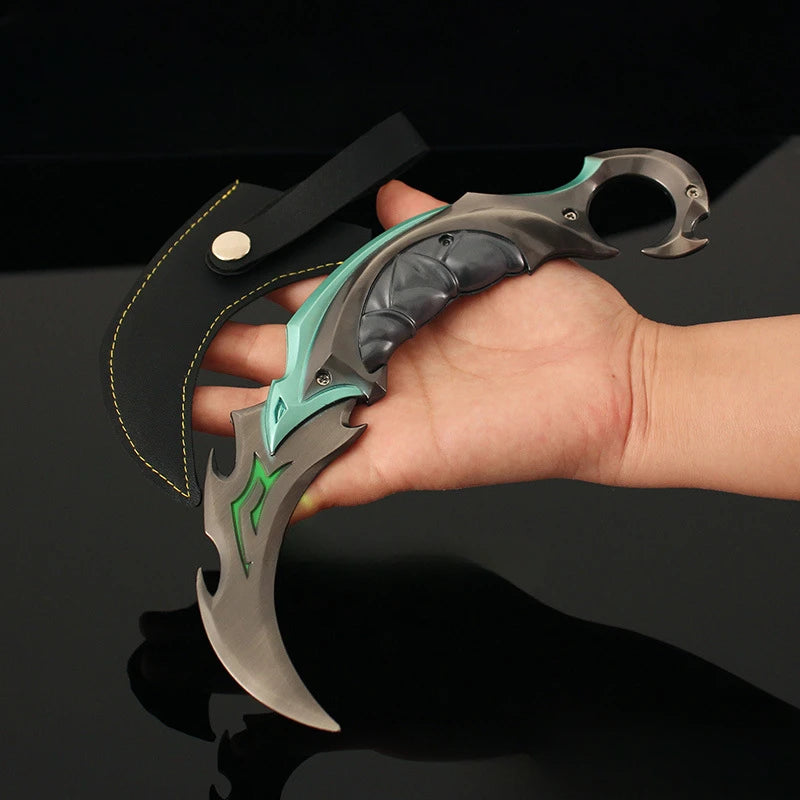 Karambit knife with teal handle, silver blade, and green graphic accents held by hand