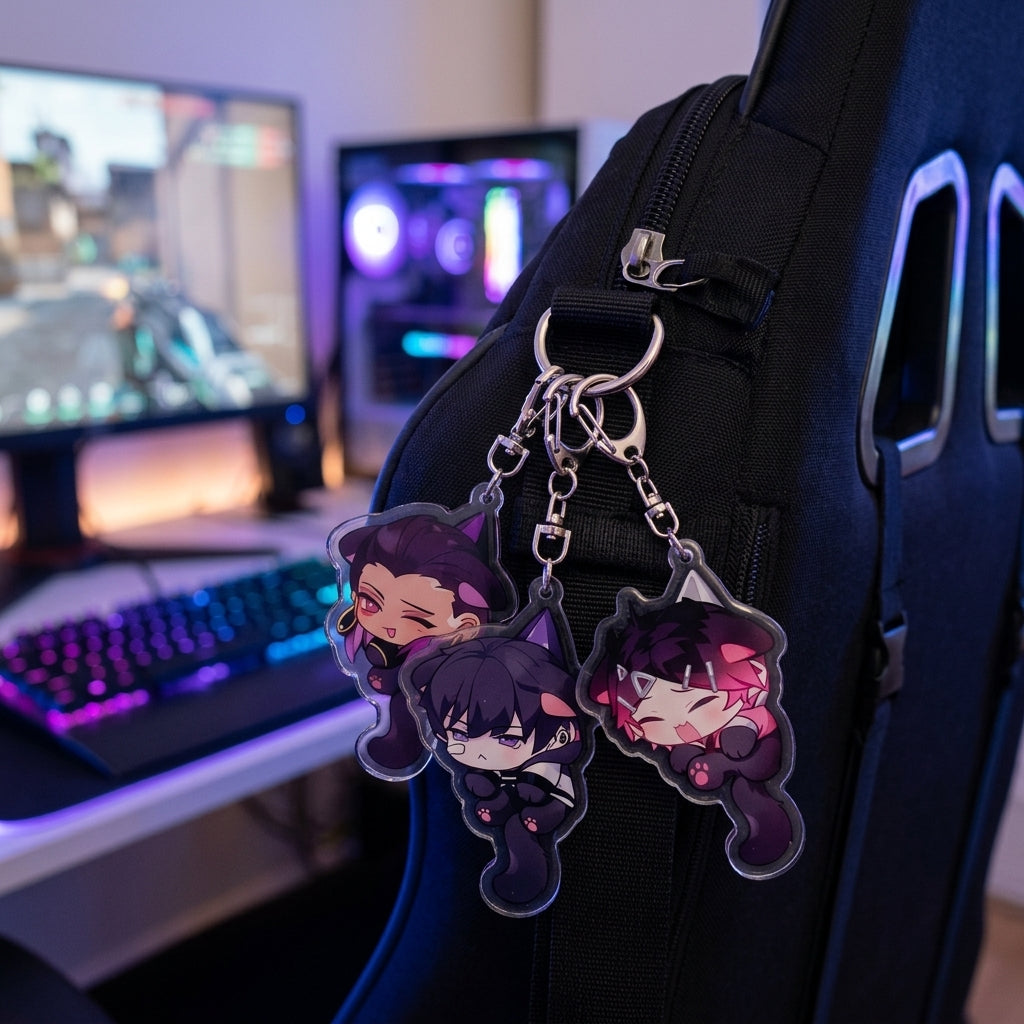 Chibi cat-ear acrylic keychains on a black backpack strap with metal rings.
