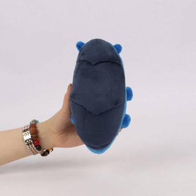Navy blue plush toy with small blue side bumps, held in a hand.