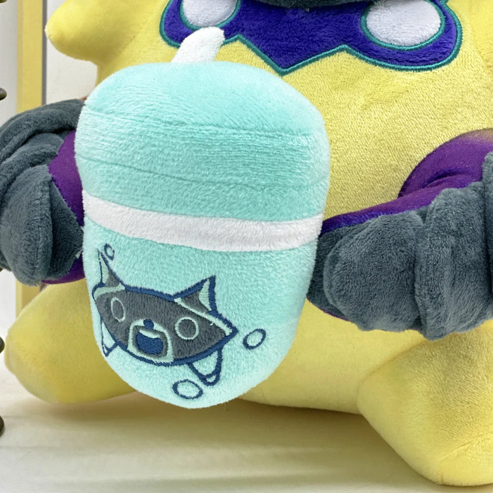 Close-up plush face patch with mint and blue stripes on a yellow body.