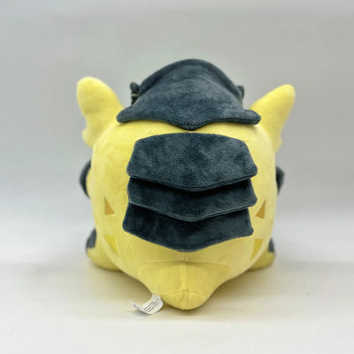 Yellow plush creature back view with dark stacked hat and wing-like ears