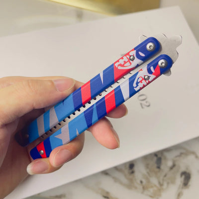 Blue and red striped butterfly-style knife with comb teeth and metal handles